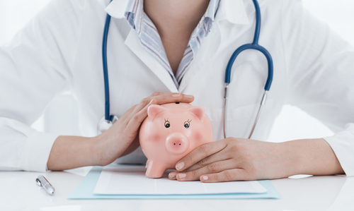 insurance doctor holding piggy bank