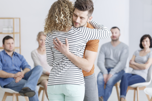 two people hugging at a drug rehab